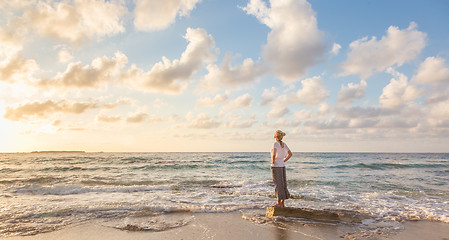 Image showing Free Happy Woman Enjoying Sunset on Sandy Beach