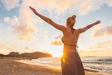 Image showing Free Happy Woman Enjoying Sunset on Sandy Beach