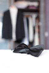 Image showing Bow tie. Open closet and tuxedo. 