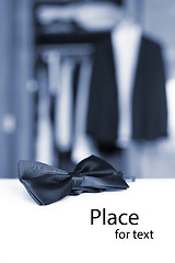 Image showing Bow tie. Open closet and tuxedo. 