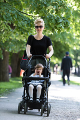 Image showing mother pushed her baby daughter in a stroller