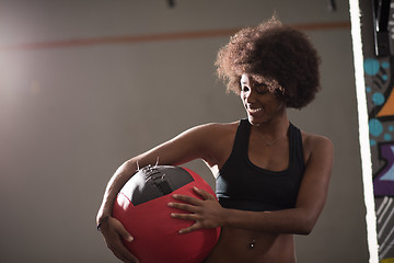 Image showing black woman carrying crossfit ball