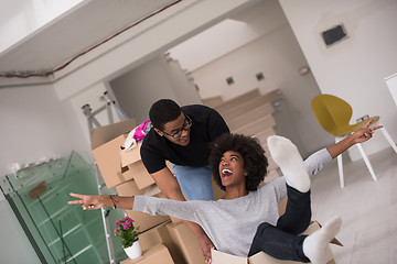 Image showing African American couple  playing with packing material