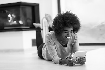 Image showing black women used tablet computer on the floor