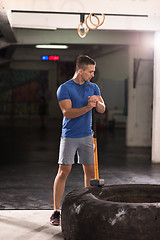 Image showing man workout with hammer and tractor tire