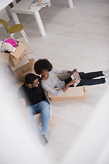 Image showing African American couple  playing with packing material