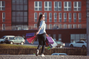 Image showing The girl walking with shopping on city streets