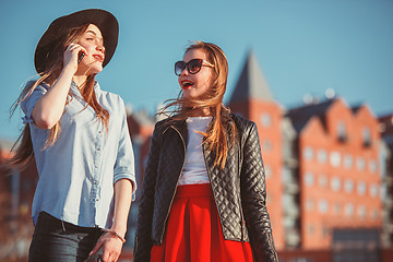 Image showing Two girls walking with shopping on city streets