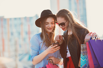 Image showing Two girls walking with shopping on city streets