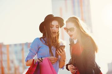 Image showing Two girls walking with shopping on city streets