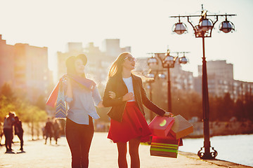 Image showing Two girls walking with shopping on city streets