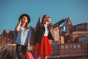 Image showing Two girls walking with shopping on city streets