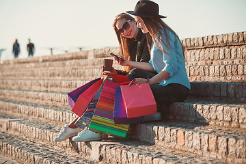 Image showing Two girls walking with shopping on city streets