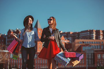 Image showing Two girls walking with shopping on city streets
