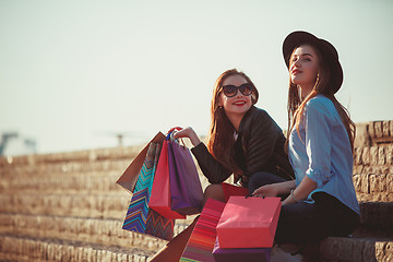 Image showing Two girls walking with shopping on city streets