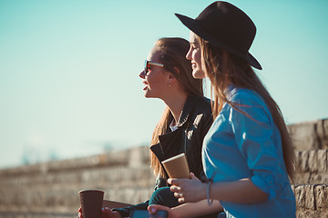 Image showing Two girls walking with shopping on city streets