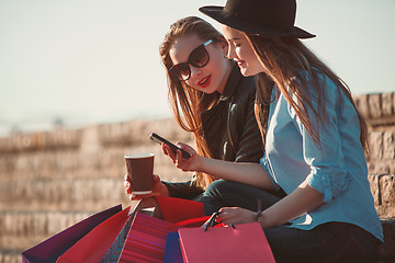 Image showing Two girls walking with shopping on city streets