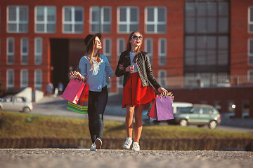 Image showing Two girls walking with shopping on city streets