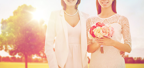 Image showing close up of happy lesbian couple with flowers