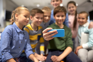 Image showing group of happy kids taking selfie with smartphone