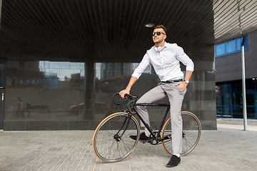 Image showing man with bicycle and headphones on city street