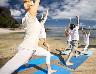 Image showing group of people making yoga exercises outdoors