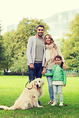 Image showing happy family with labrador retriever dog in park