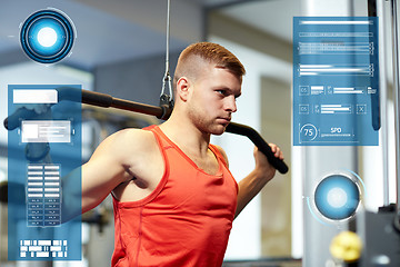 Image showing man flexing muscles on cable machine gym