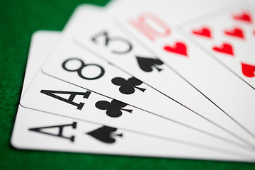 Image showing poker hand of playing cards on green casino cloth