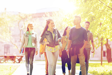 Image showing group of happy teenage students walking outdoors