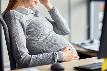 Image showing pregnant businesswoman sitting at office