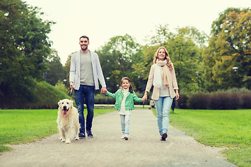 Image showing happy family with labrador retriever dog in park