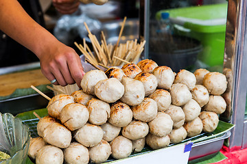 Image showing seller hand with meatballs at street market