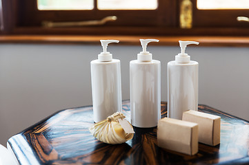 Image showing bottles with liquid soap or lotion at spa