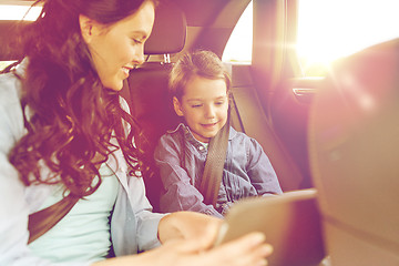 Image showing happy family with tablet pc driving in car