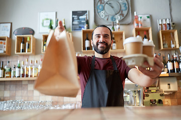 Image showing man or waiter with coffee and paper bag at bar