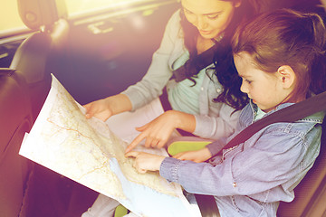 Image showing happy family with travel map driving in car