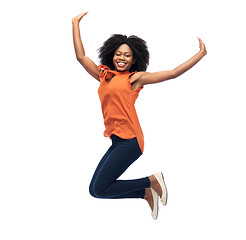 Image showing happy african american woman jumping over white