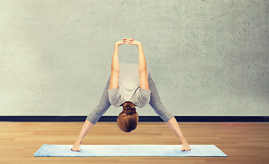 Image showing woman making yoga in wide-legged forward bend pose