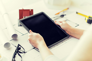 Image showing close up of hand with blueprint and tablet pc