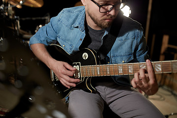 Image showing man playing guitar at studio rehearsal