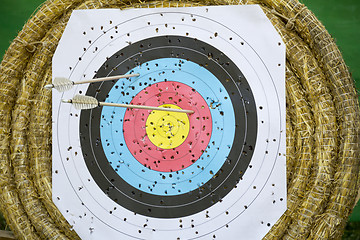Image showing Archery Target With Arrows On a straw background