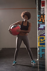 Image showing black woman carrying crossfit ball