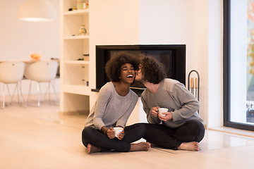 Image showing multiethnic couple  in front of fireplace