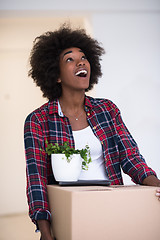 Image showing Black girl moving in the new apartment