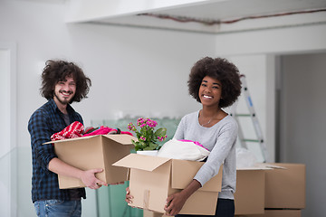 Image showing multiethnic couple moving into a new home