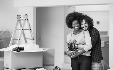 Image showing multiethnic couple moving into a new home