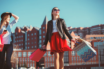 Image showing Two girls walking with shopping on city streets