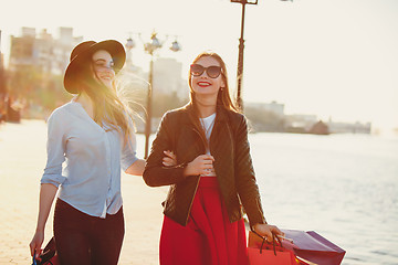 Image showing Two girls walking with shopping on city streets