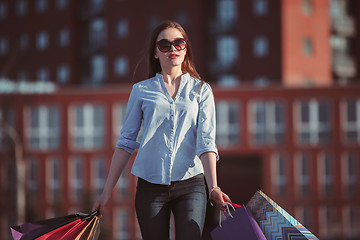 Image showing The girl walking with shopping on city streets